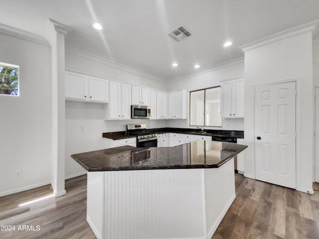 kitchen featuring a center island, wood-type flooring, stainless steel appliances, and white cabinets