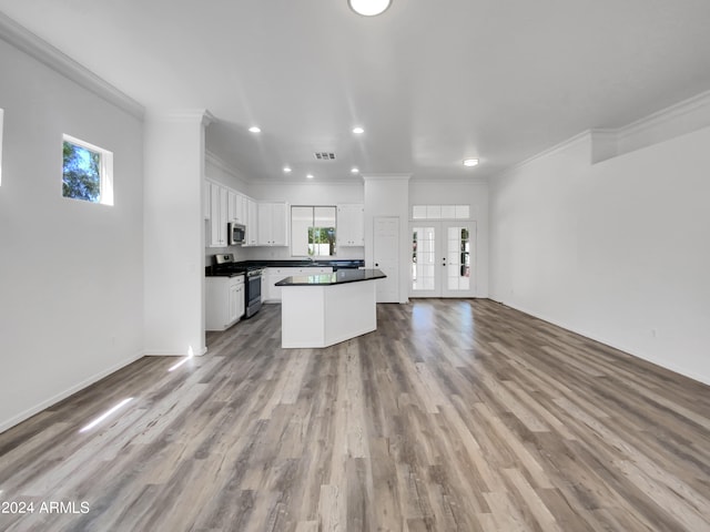 kitchen featuring appliances with stainless steel finishes, a healthy amount of sunlight, and hardwood / wood-style flooring