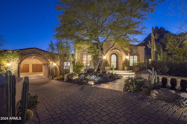 mediterranean / spanish-style house with a garage