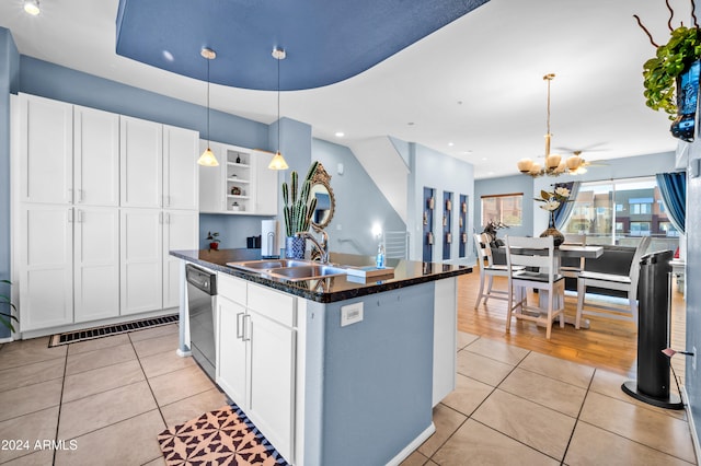 kitchen featuring white cabinetry, a kitchen island with sink, sink, and light tile patterned floors