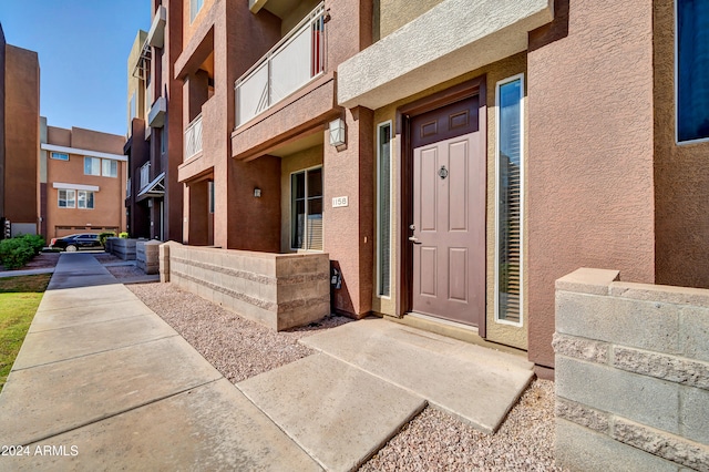 view of exterior entry featuring a balcony