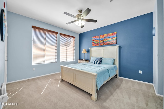 bedroom featuring light colored carpet and ceiling fan