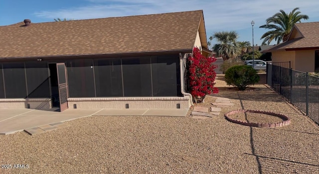 back of house featuring a sunroom