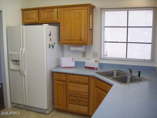 kitchen featuring sink, a healthy amount of sunlight, and white refrigerator with ice dispenser