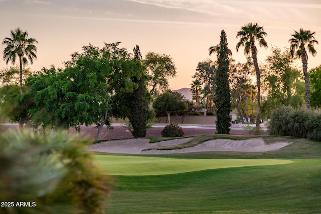 view of home's community with a lawn and golf course view