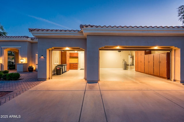 view of front facade with a garage, stucco siding, and concrete driveway