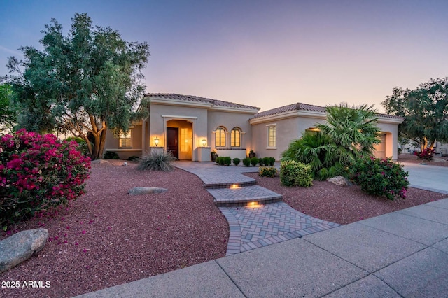 mediterranean / spanish-style house featuring stucco siding and driveway