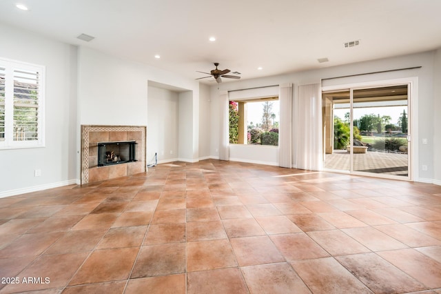 unfurnished living room with visible vents, recessed lighting, ceiling fan, and a tile fireplace