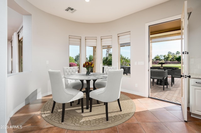 dining space featuring visible vents and light tile patterned floors