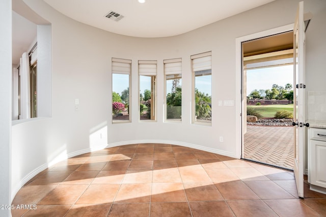 entrance foyer with light tile patterned floors and visible vents
