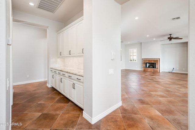 interior space featuring baseboards, recessed lighting, light tile patterned flooring, and visible vents