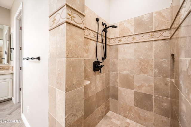 full bathroom featuring vanity and a tile shower