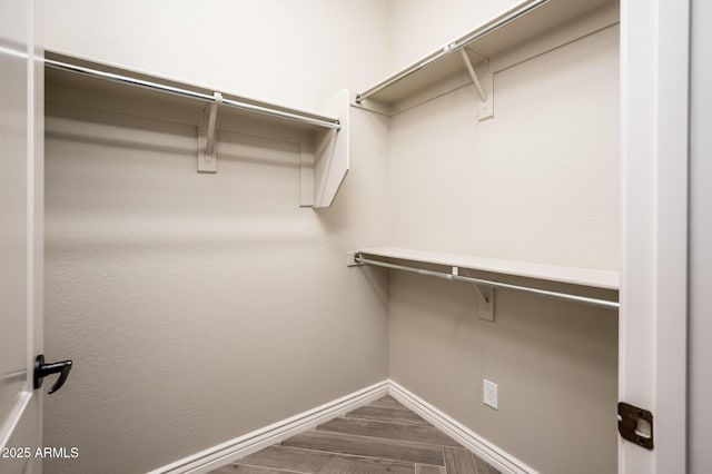 walk in closet featuring wood finished floors