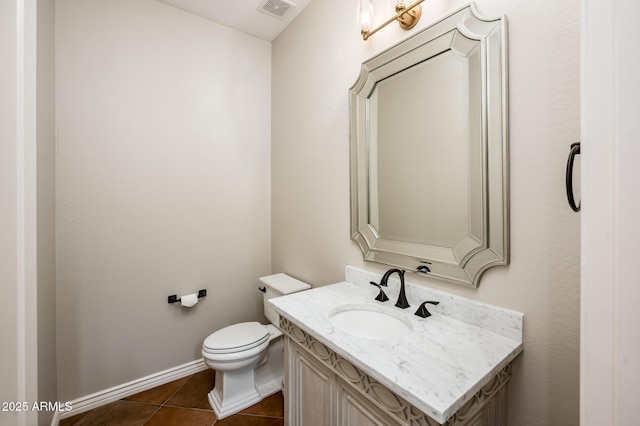 half bath featuring visible vents, tile patterned flooring, vanity, baseboards, and toilet