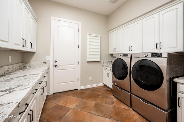 washroom with cabinet space, separate washer and dryer, baseboards, and visible vents