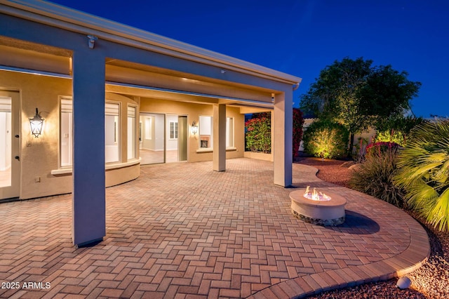 patio at twilight with a fire pit