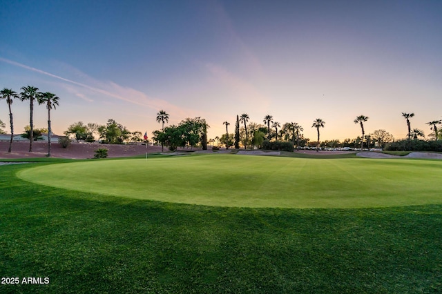 view of property's community with a yard and golf course view