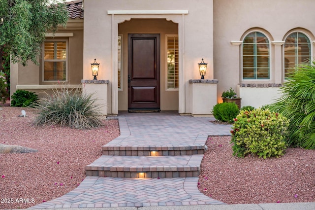 property entrance featuring stucco siding