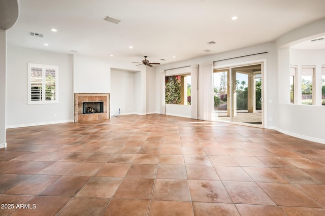 unfurnished living room featuring baseboards, recessed lighting, a ceiling fan, and a wealth of natural light