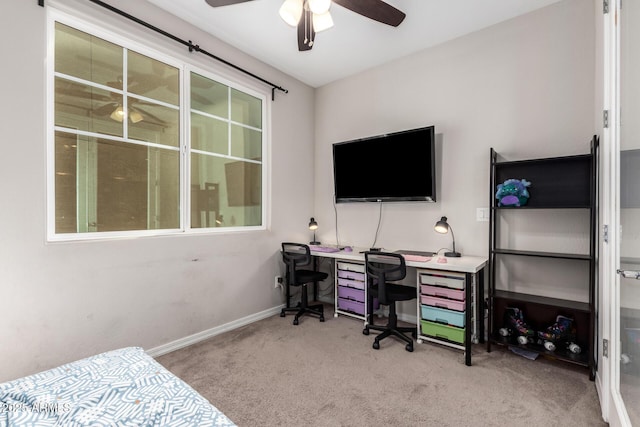 home office featuring ceiling fan, a wealth of natural light, and light carpet