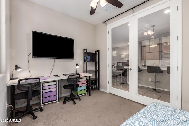 carpeted office space with ceiling fan and french doors