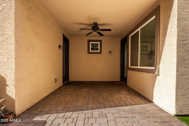 exterior space with ceiling fan