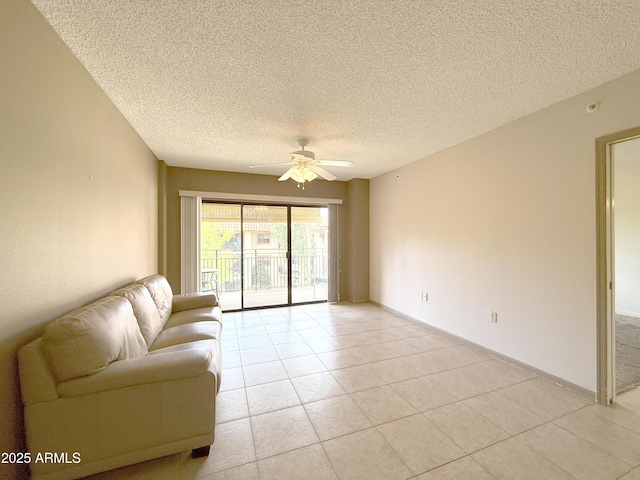 tiled living room featuring a textured ceiling and ceiling fan