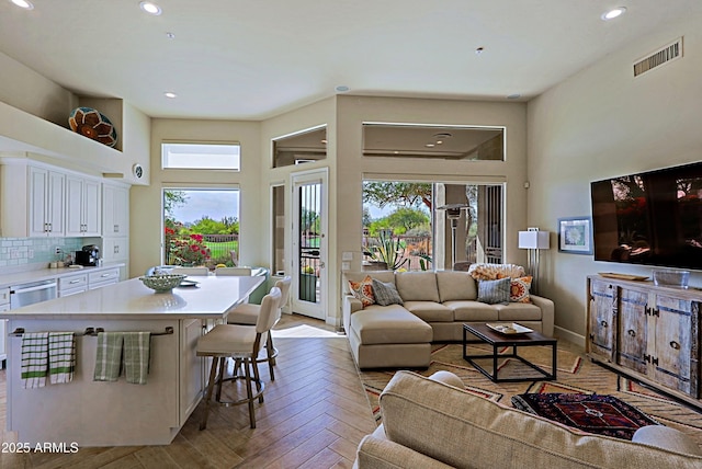 living room with recessed lighting, baseboards, and visible vents