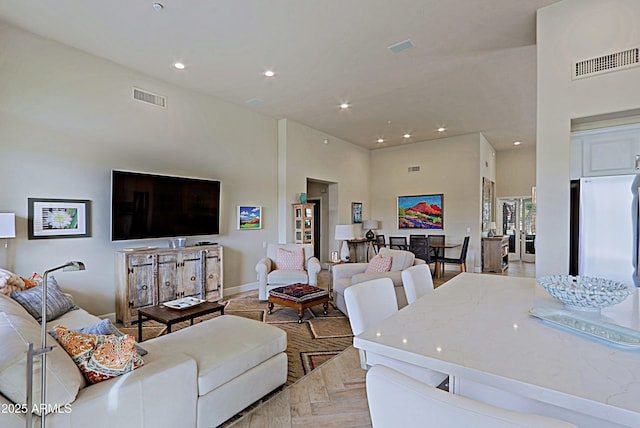 living area featuring recessed lighting, baseboards, and visible vents