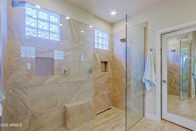 full bath with a walk in shower and visible vents