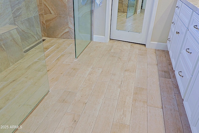 interior space featuring baseboards and wood finished floors