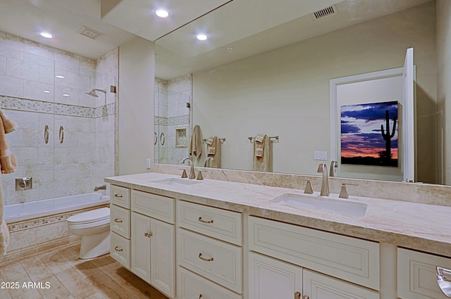 bathroom featuring a sink, double vanity, and visible vents