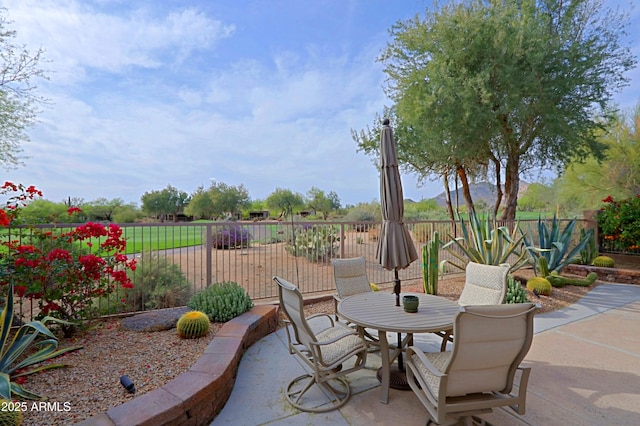 view of patio featuring fence and outdoor dining space