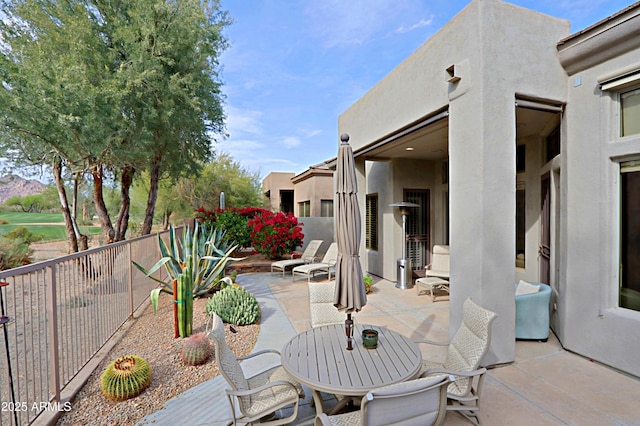 view of patio featuring fence and outdoor dining space