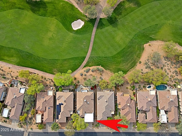 drone / aerial view with view of golf course and a residential view
