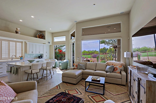 living area featuring recessed lighting and a high ceiling