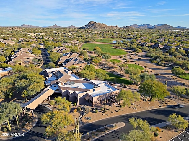 drone / aerial view with view of golf course, a residential view, and a mountain view