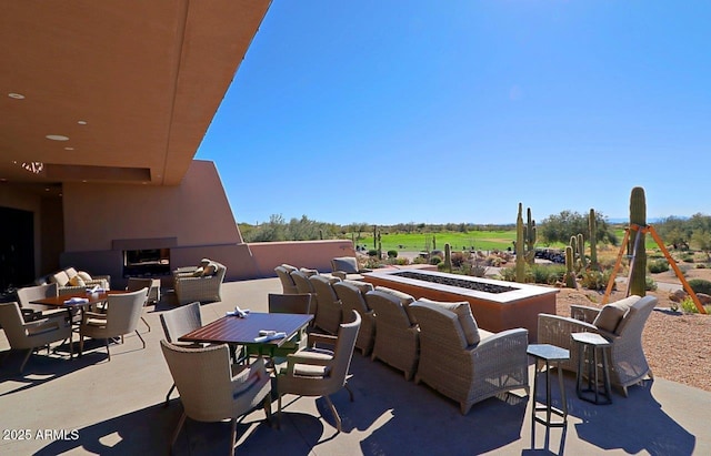 view of patio with outdoor dining area and an outdoor fire pit