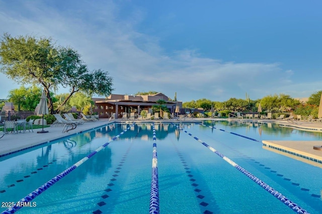 pool featuring fence and a patio