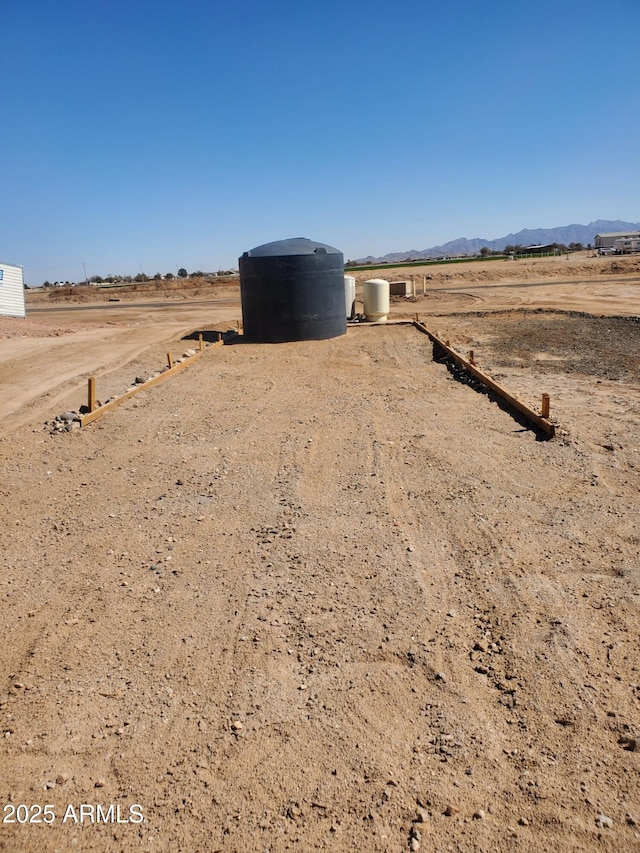 view of yard with a mountain view and a rural view