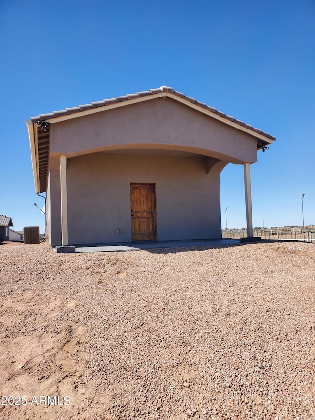 exterior space with central air condition unit and stucco siding