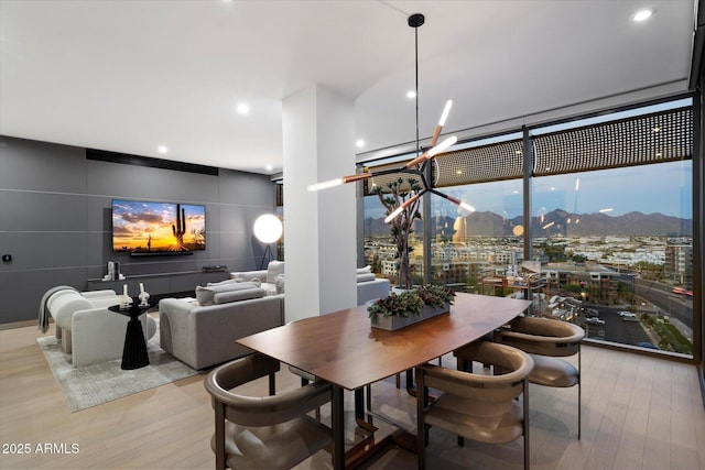 7180 E Kierland Blvd Unit 1116, Scottsdale, AZ 85254 - dining area with wood finished floors, a wall of windows, recessed lighting, and a chandelier