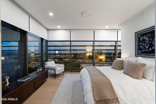7180 E Kierland Blvd Unit 1116, Scottsdale, AZ 85254 - bedroom with light wood finished floors, a wall of windows, and recessed lighting