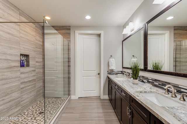 bathroom with vanity and a shower with shower door