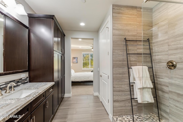 bathroom featuring ceiling fan, vanity, and an enclosed shower