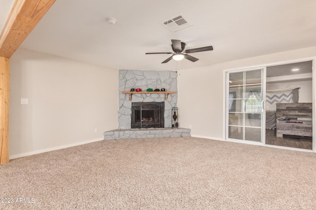 unfurnished living room featuring a fireplace, ceiling fan, and carpet