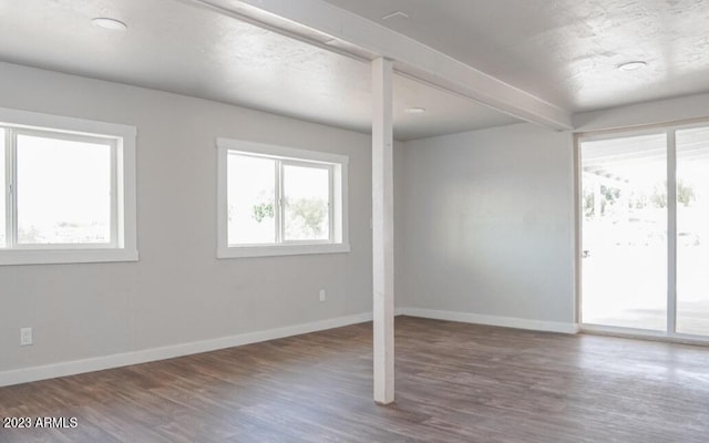 spare room with dark wood-type flooring