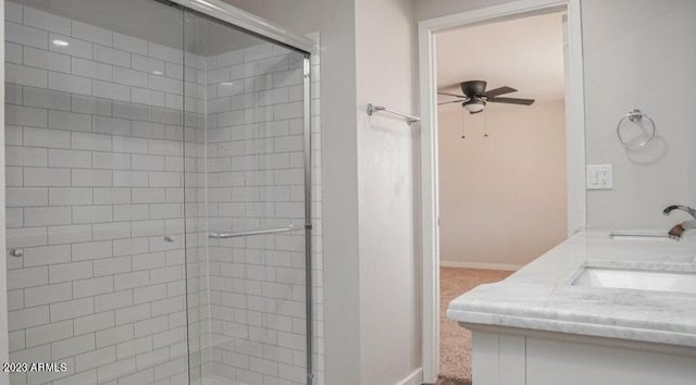 bathroom featuring walk in shower, vanity, and ceiling fan