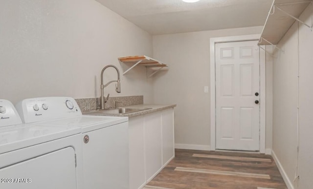 clothes washing area with sink, dark hardwood / wood-style floors, and washing machine and clothes dryer