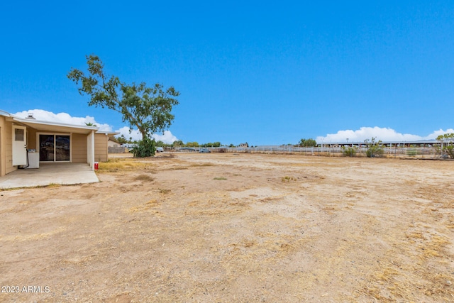 view of yard featuring a rural view and a patio